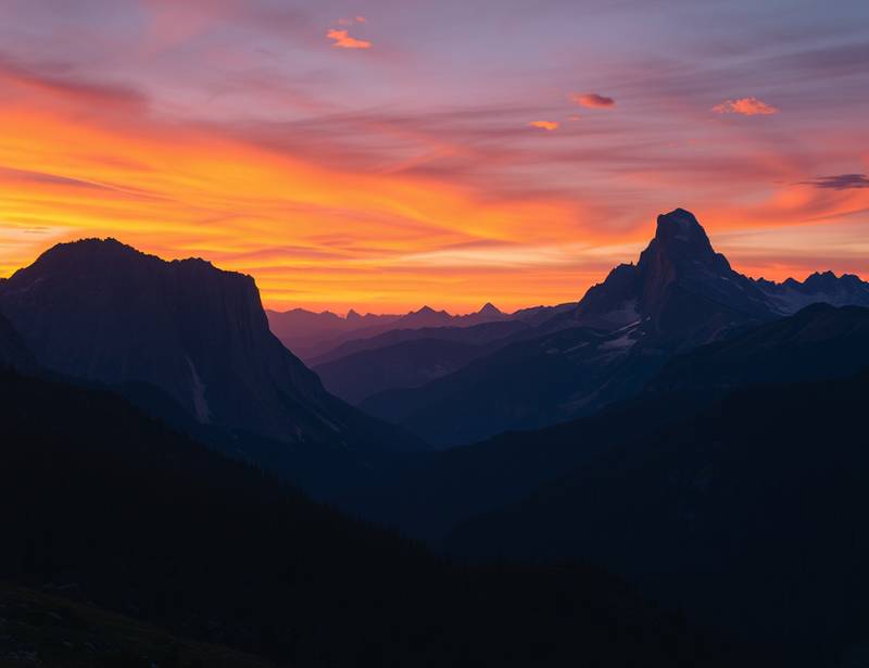 A stunning landscape photograph featuring mountains and a vibrant sunset.
